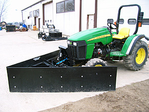 Feed Plow on a compact tractor.